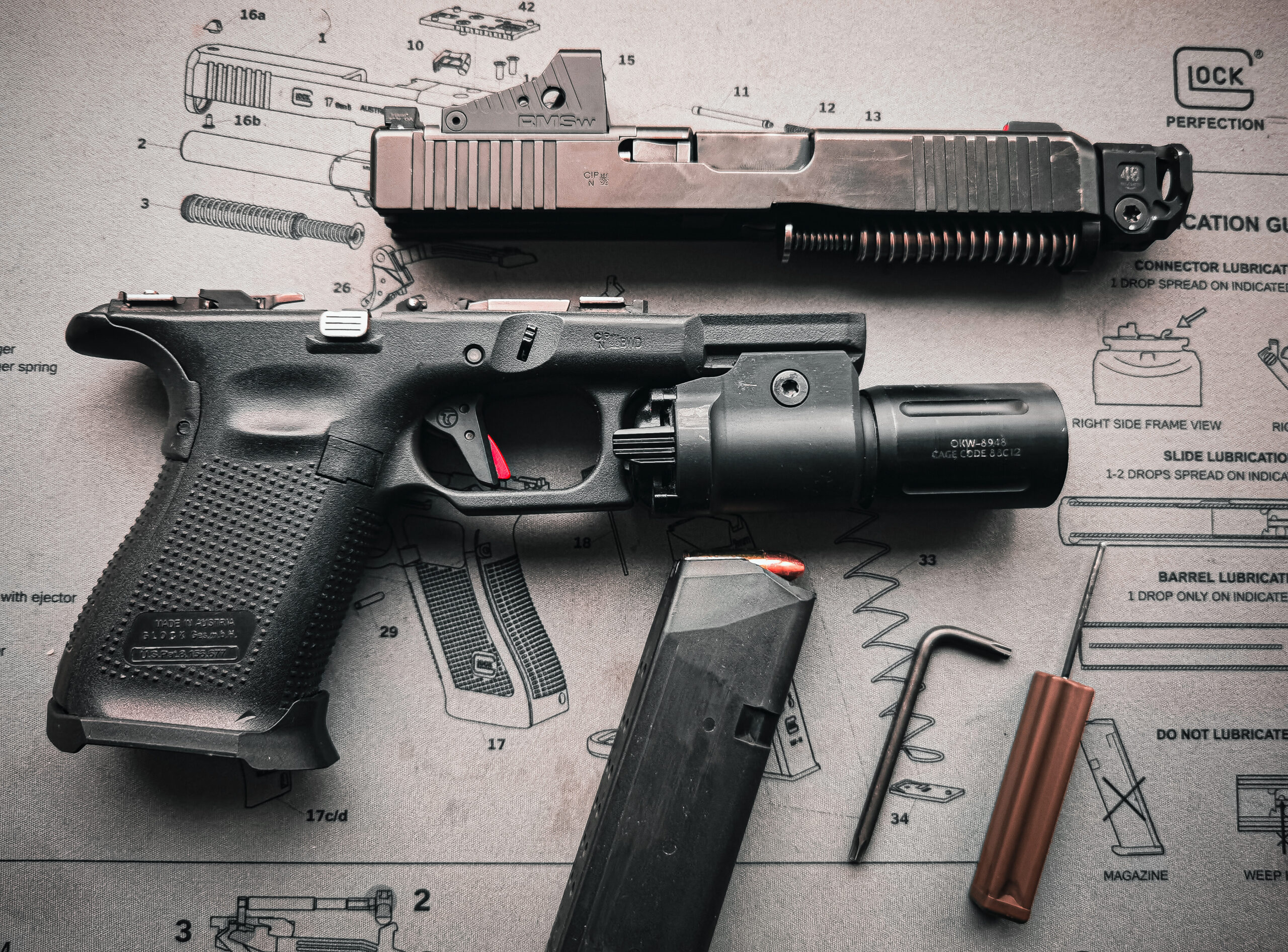 Baltic States, March 16, 2024. A disassembled Glock 19gen 5 tactical pistol with a weapon flashlight and a red dot sight.